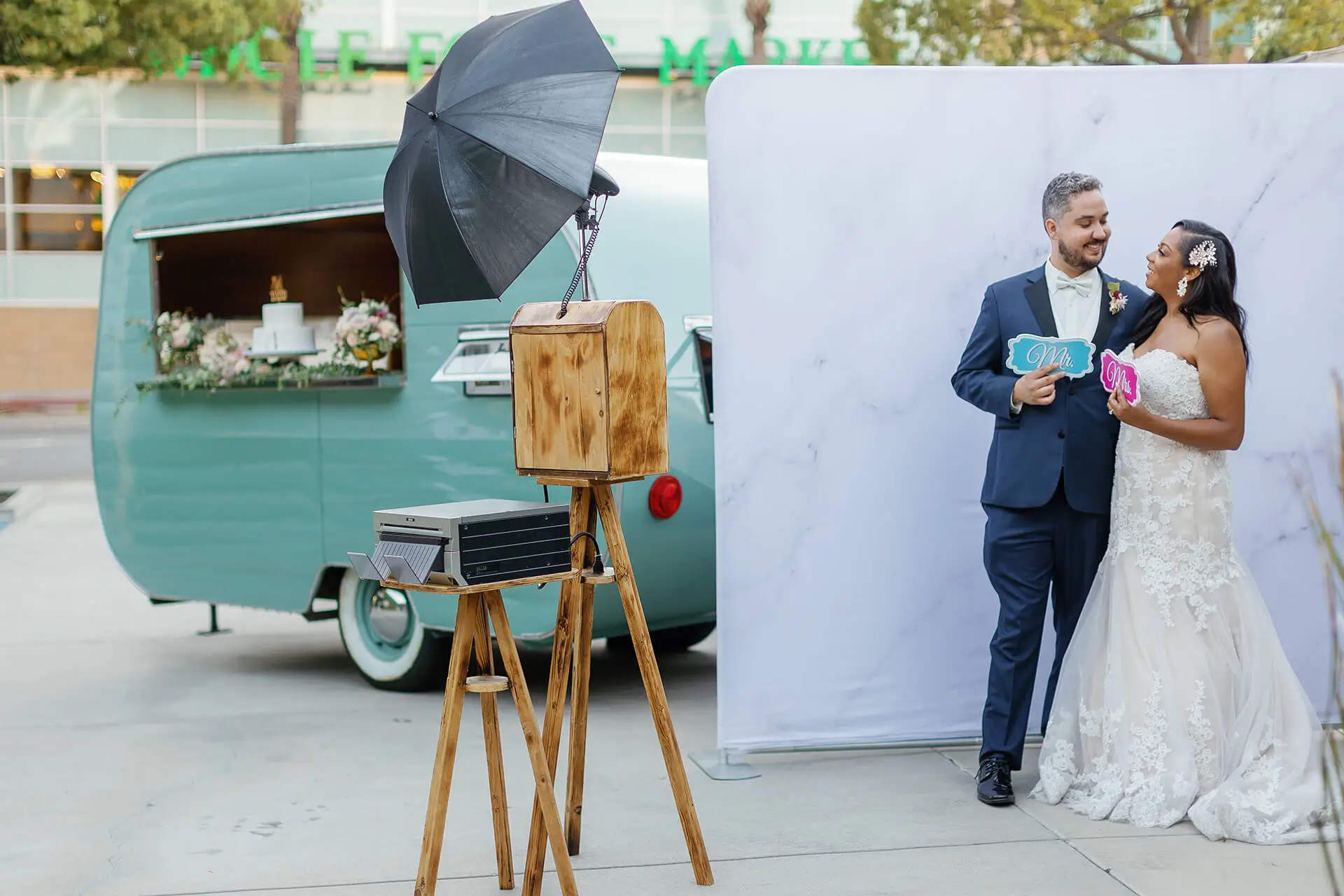 The wooden 29PM photo booth at an outdoor wedding