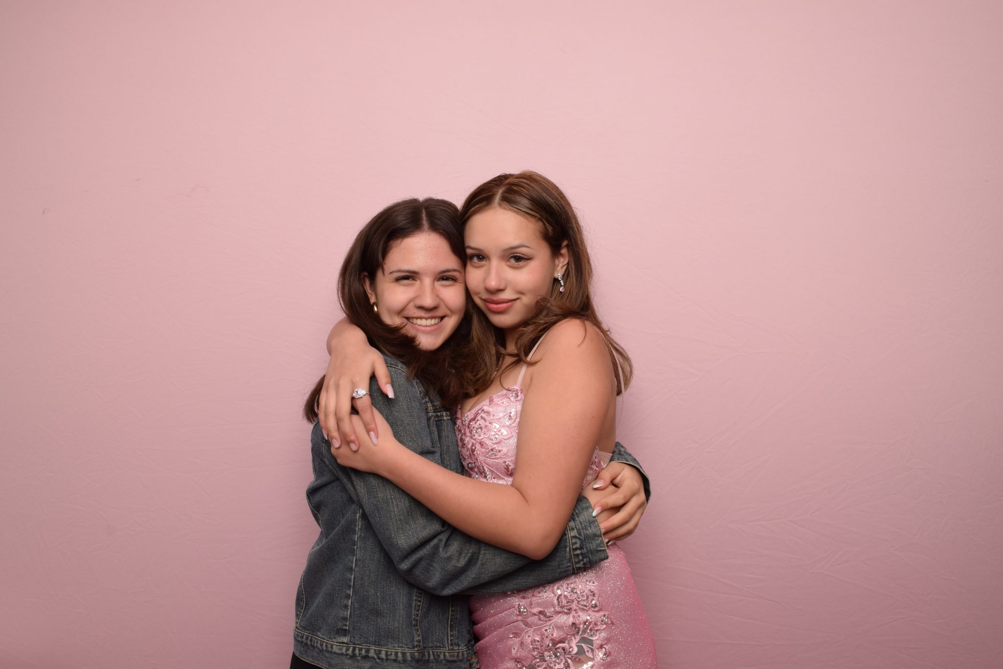 Guests posing against a blush backdrop at a 29PM event